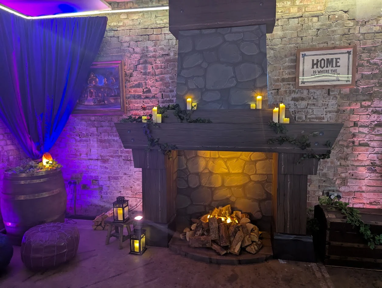 Another photo of the event decor, focusing on a cozy fireplace.
