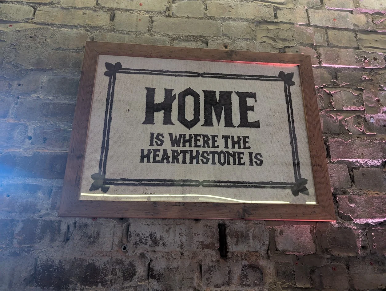 A photo of a Home is where the Hearthstone is cross stitch